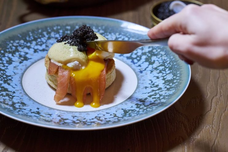 Gourmet breakfast spread at Pavyllon showcasing artisan pastries, fresh fruit, and elegant table setting for a luxurious d...