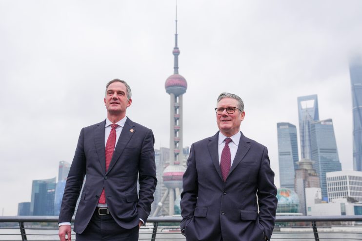 Peter Kyle and Keir Starmer engaged in discussion at a political event, emphasizing leadership and collaboration.