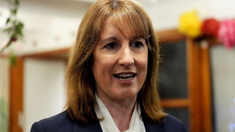 Rachel Reeves delivering a speech at a business conference, highlighting economic strategies and engaging with an audience.