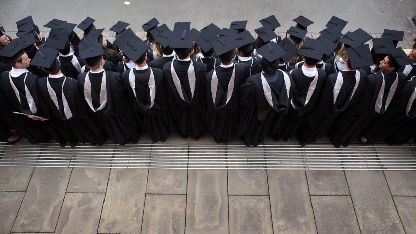 UK university graduates celebrating in caps and gowns, showcasing academic achievement and success in higher education.