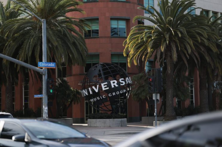 Universal Music Group logo on a sleek building facade in a bustling cityscape, reflecting the companys global influence in...
