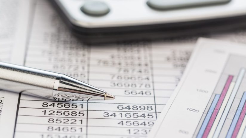 Financial accounts overview with charts, graphs, and spreadsheets on a desk, illustrating business analysis and reporting.