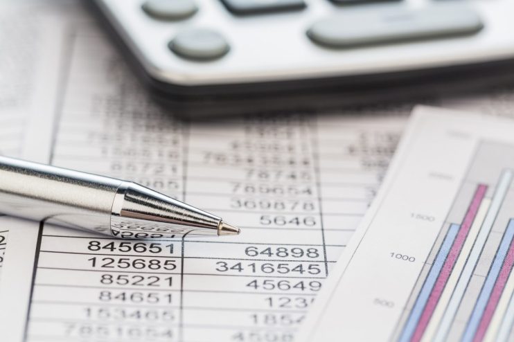 Financial accounts overview with charts, graphs, and spreadsheets on a desk, illustrating business analysis and reporting.
