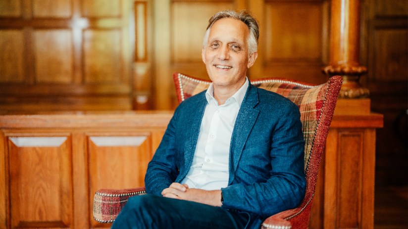 Danny Pecorelli in a business setting, discussing hospitality industry insights and leadership strategies at a conference.