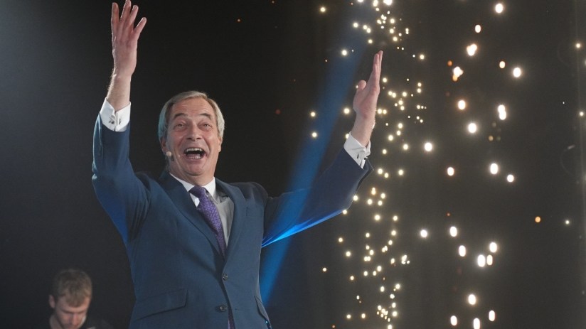 Nigel Farage watching fireworks display during a public event, highlighting celebration and political engagement