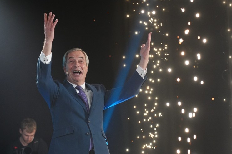 Nigel Farage watching fireworks display during a public event, highlighting celebration and political engagement