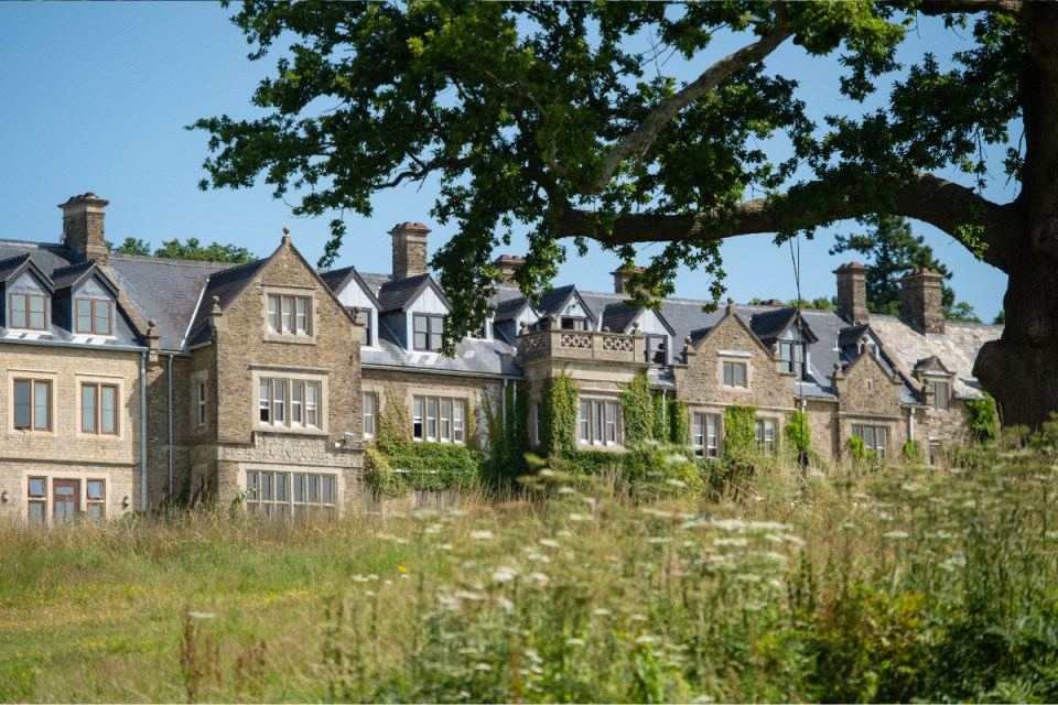 South Lodge exterior view showcasing elegant architecture and manicured gardens in a serene setting