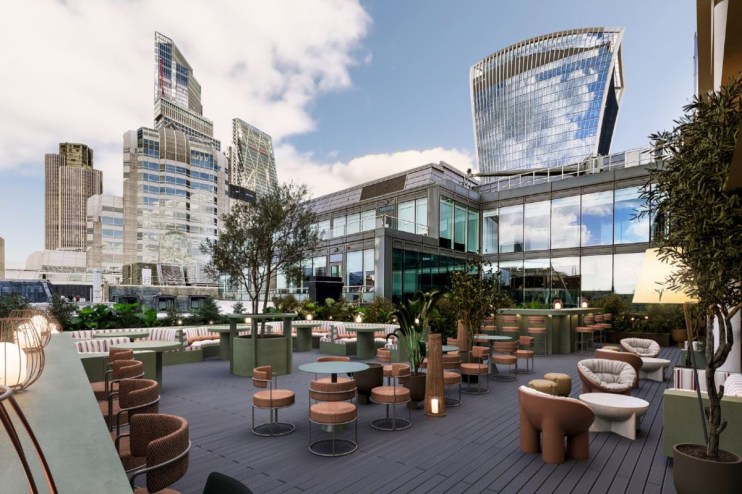 City skyline from rooftop office, showcasing modern architecture and bustling urban life on a clear day.