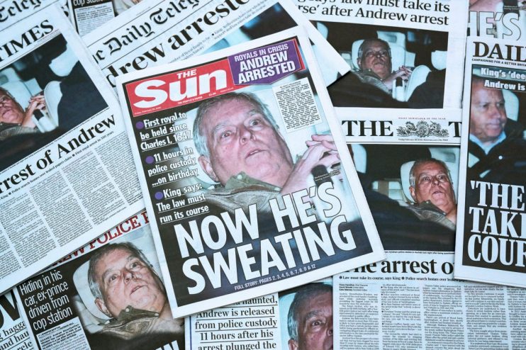 Andrew Mountbatten Windsor reading newspapers, possibly discussing current events or related news topics, in a formal setting