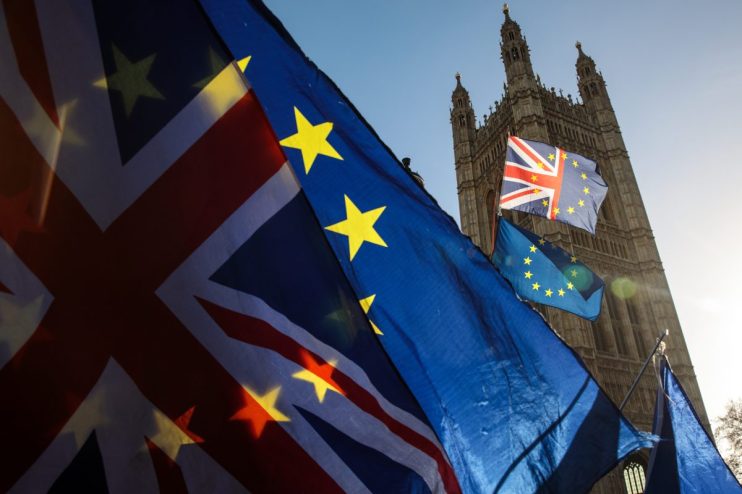 UK-EU Brexit negotiations meeting with officials discussing trade agreements and policy impacts in a formal conference room