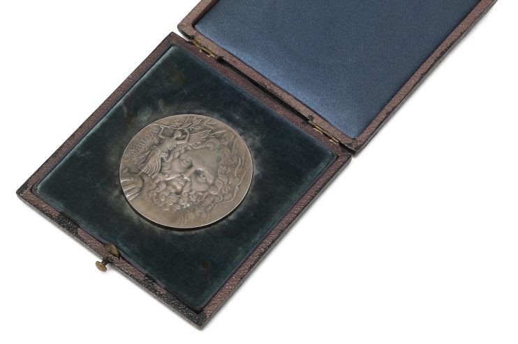 Silver medal from the first Olympic Games in Athens 1896, Greece, displayed in an ornate presentation box.