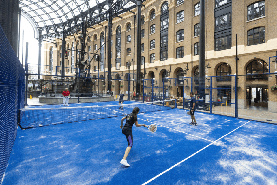 Players enjoying a lively padel match at the vibrant Hays Galleria during the London Sports Festival