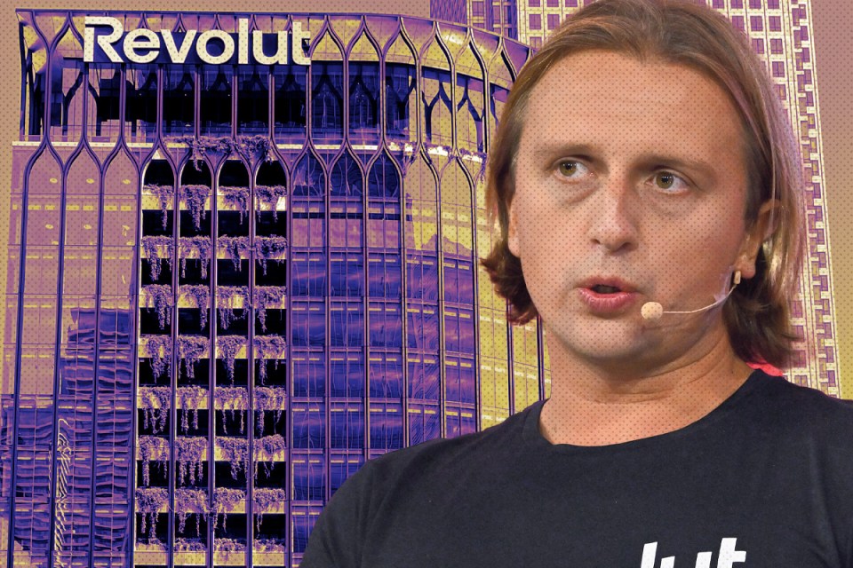 Revolut app interface on smartphone screen showcasing financial transaction features, set against a modern office background.