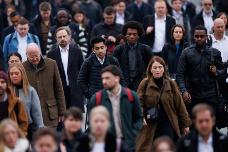 London commuters navigating busy streets during rush hour, showcasing urban lifestyle and public transportation dynamics.