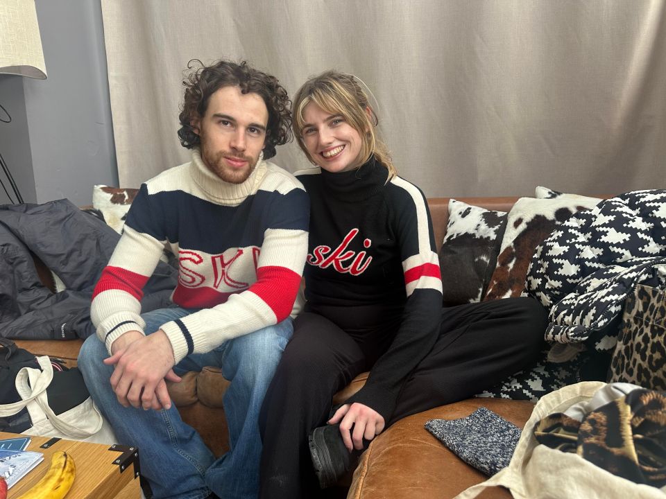 A couple skiing together on a snowy slope, showcasing winter sports and outdoor adventure in a picturesque alpine setting.