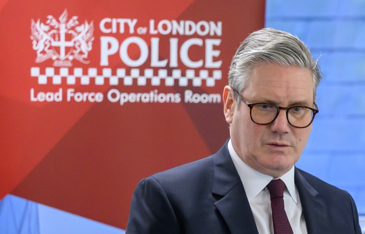 Keir Starmer engaging with Canada Police officers in a formal meeting setting, discussing urban safety initiatives.