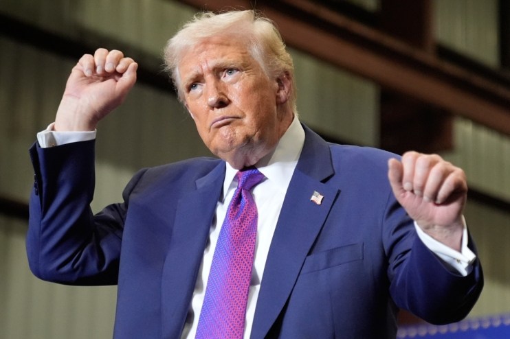Donald Trump dancing at a campaign rally in Pennsylvania, engaging supporters with enthusiastic gestures and lively expres...