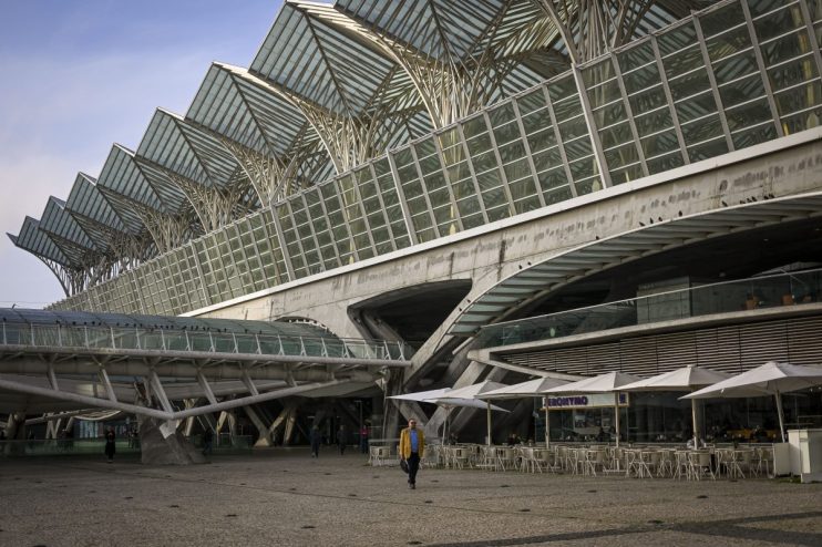 Lisbon train station bustling with commuters, showcasing modern architecture and vibrant city atmosphere during rush hour