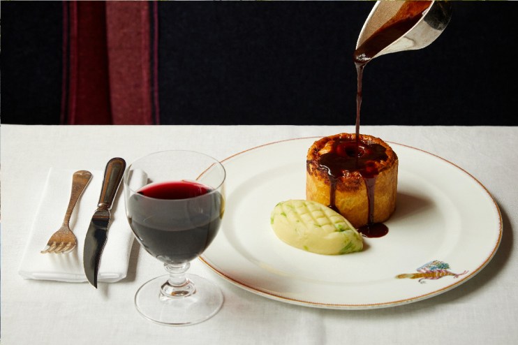 Freshly baked pie with golden crust on a wooden table, highlighting culinary craftsmanship in a general news article context