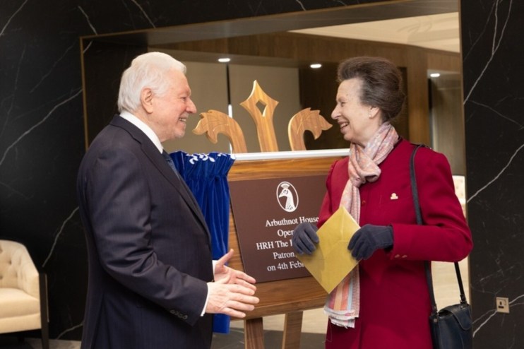 Sir Henry Angest with HRH, formal business attire, engaging in discussion at a corporate event, highlighting leadership ex...