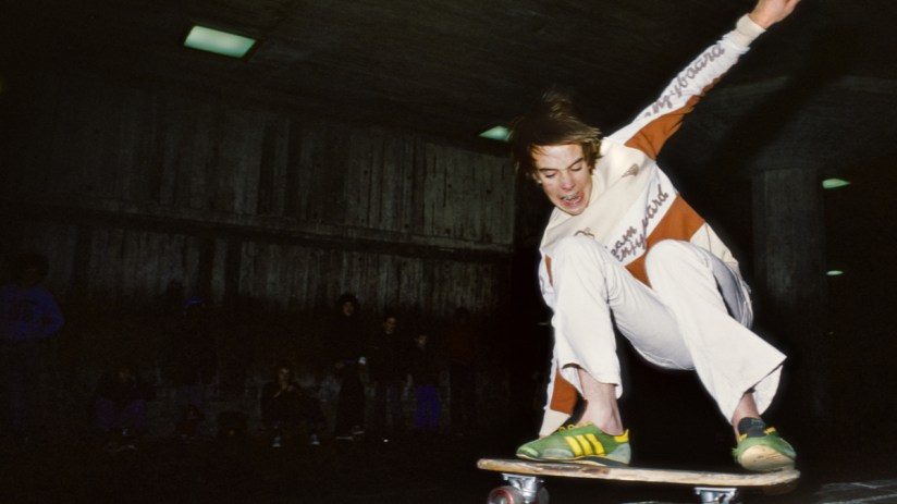 Skateboarding enthusiast performing a trick on a vibrant city street, showcasing urban culture and dynamic movement