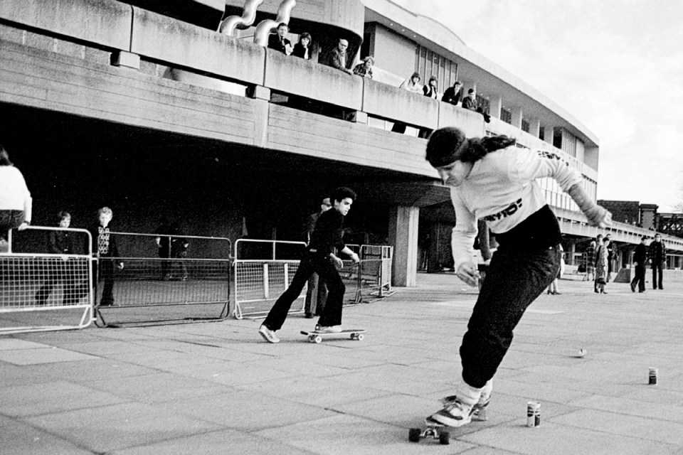 Professional skateboarder performing a trick during a competitive event, showcasing skill and athleticism in skateboarding.