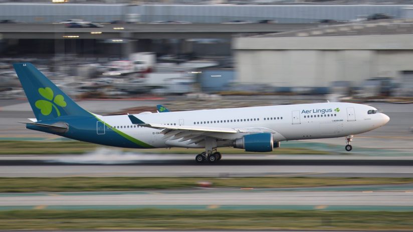 Aer Lingus aircraft on runway at sunrise, highlighting airlines operations and fleet in vibrant morning hues.