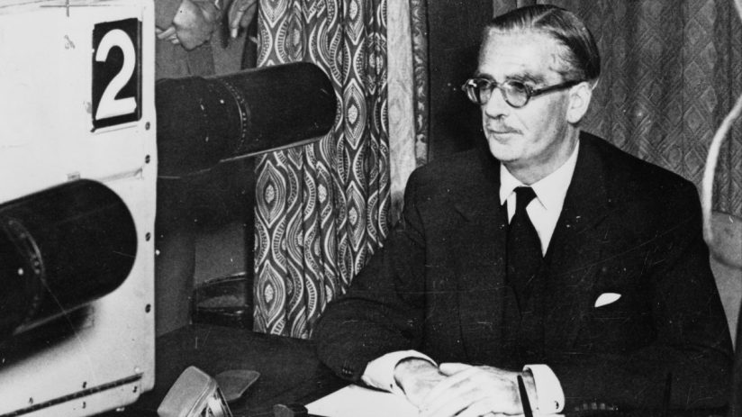 British Prime Minister Anthony Eden during the Suez Crisis, addressing the nation with a stern expression and formal attire.