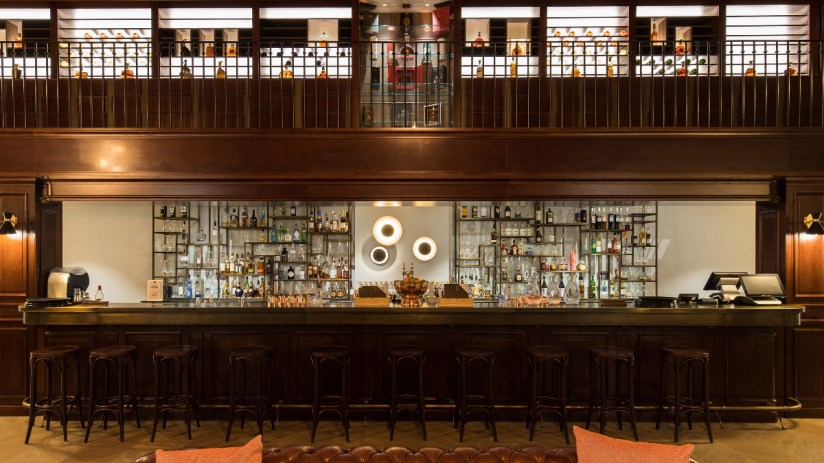 Elegant interior of Bar 1838 at Hotel Chais Monnet Spa showcasing sophisticated decor and ambient lighting.