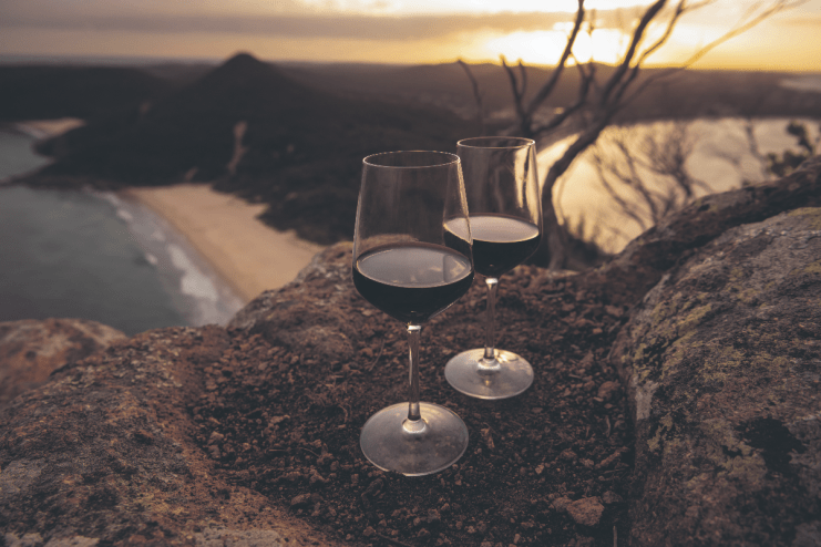 Award-winning Australian wine bottle with vineyard backdrop, showcasing premium wine selection in a business news context
