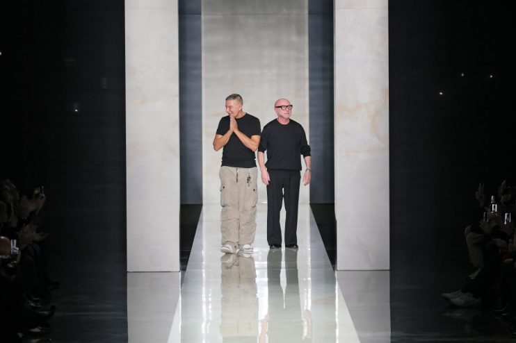 Dolce & Gabbana fashion collection showcase with elegant models on runway in vibrant, luxurious attire