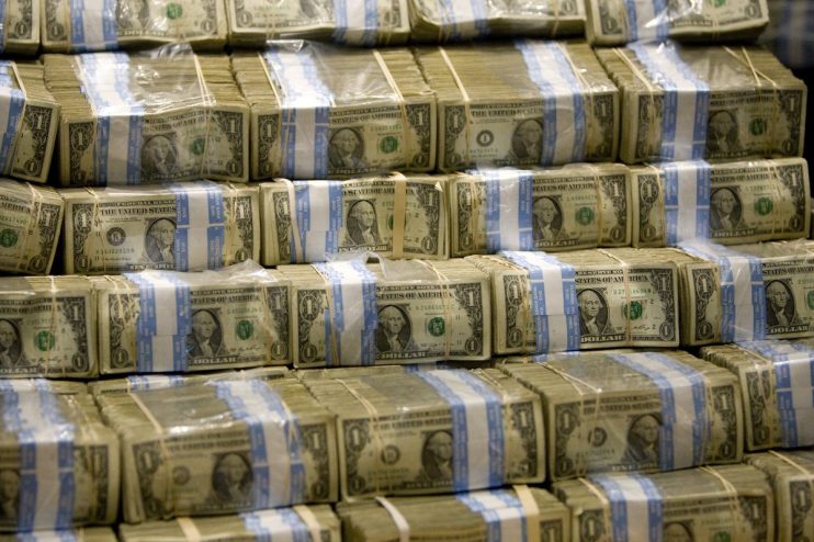 Close-up view of US dollar bills fanned out, highlighting currency detail, representing economic and financial news topics.