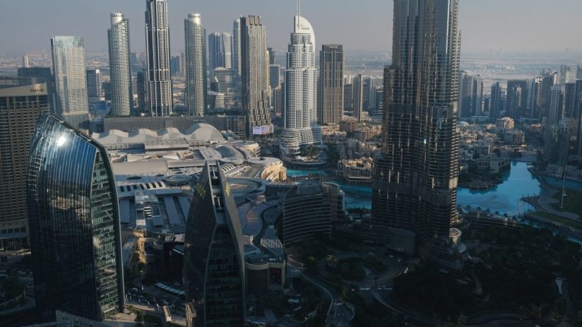 Dubai skyline featuring iconic skyscrapers and modern architecture under a clear blue sky, showcasing the citys urban land...
