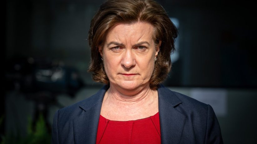 First Minister of Wales Eluned Morgan standing at a podium during a press conference, addressing current Welsh policies