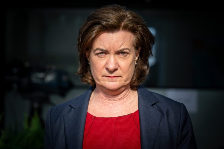 First Minister of Wales Eluned Morgan standing at a podium during a press conference, addressing current Welsh policies