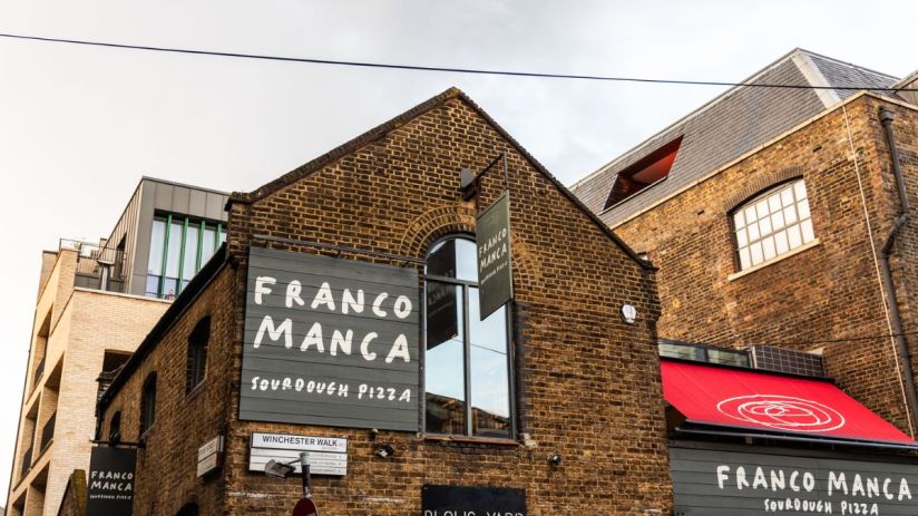 Franco Manca restaurant exterior showcasing the vibrant storefront and bustling street atmosphere in a busy city location.