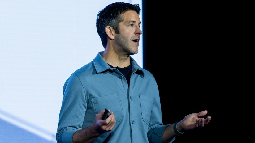 GettyImages 2264522638 featuring a business conference with diverse professionals engaging in a dynamic discussion.