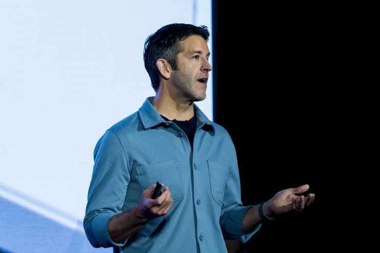 GettyImages 2264522638 featuring a business conference with diverse professionals engaging in a dynamic discussion.