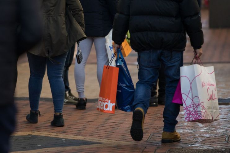 High street bustling with shoppers and vibrant storefronts, showcasing dynamic urban life and economic activity