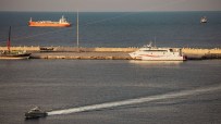Bustling shipping activity in the Strait of Hormuz with tankers and cargo ships navigating Iranian waters.