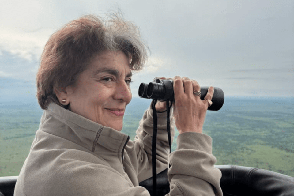 Tanzania hot air balloon safari floating over Serengeti landscape with scenic views of wildlife and savannah at sunrise