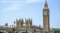 Houses of Parliament in Westminster showcasing historic architecture under a clear sky, central to UK government and politics