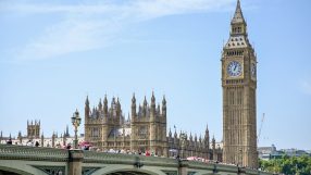 Houses of Parliament in Westminster showcasing historic architecture under a clear sky, central to UK government and politics
