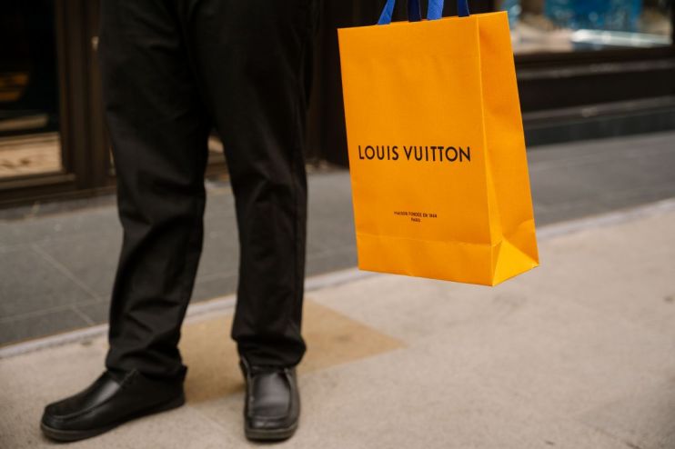 Louis Vuitton luxury handbag display in a high-end retail store showcasing elegant designer fashion accessories.