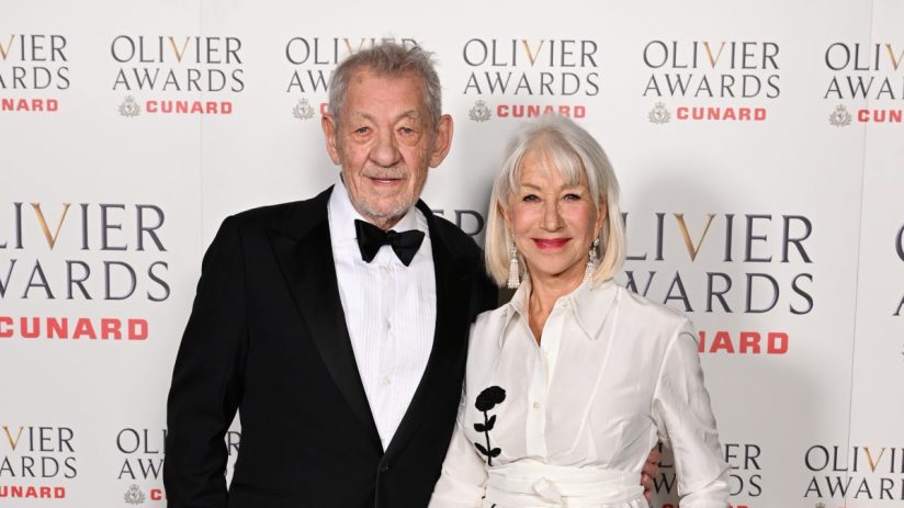 Olivier Awards ceremony stage with spotlight on presenters and audience in elegant attire, celebrating theater excellence