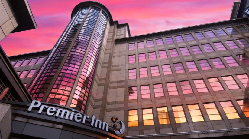 Premier Inn hotel exterior showcasing Whitbread branding and modern architecture in a bustling urban setting