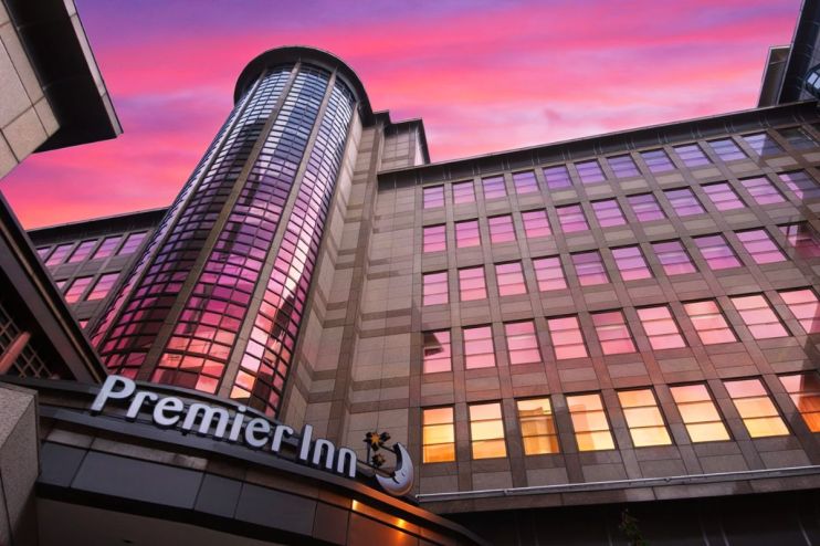Premier Inn hotel exterior showcasing Whitbread branding and modern architecture in a bustling urban setting