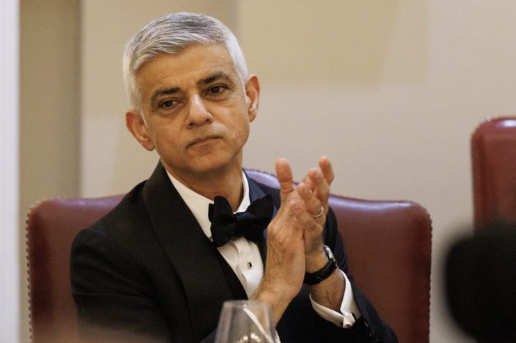 Sadiq Khan speaking at a public event, addressing current issues and engaging with an audience in a formal setting