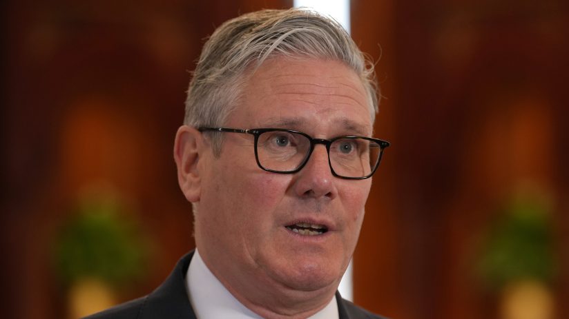 Sir Keir Starmer in formal attire during his diplomatic visit to Qatar, engaging in discussions with Qatar officials.
