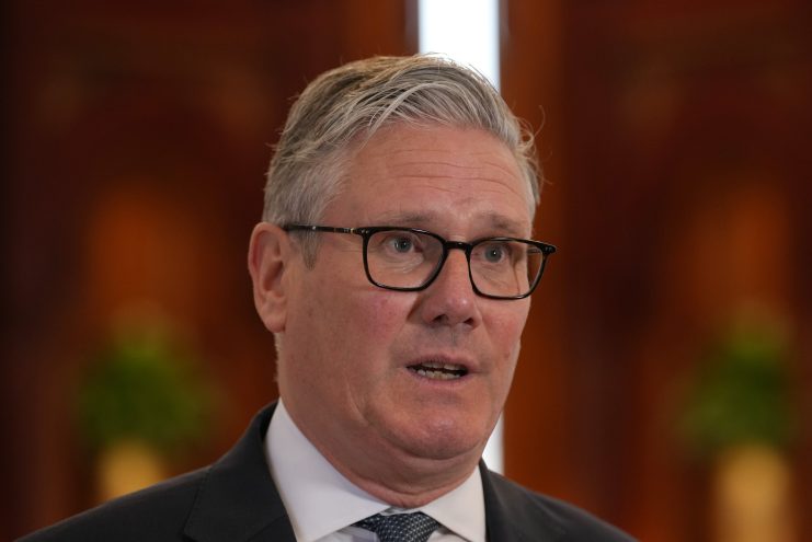 Sir Keir Starmer in formal attire during his diplomatic visit to Qatar, engaging in discussions with Qatar officials.